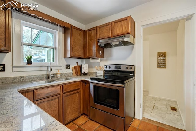 kitchen featuring sink, electric range, and light stone countertops