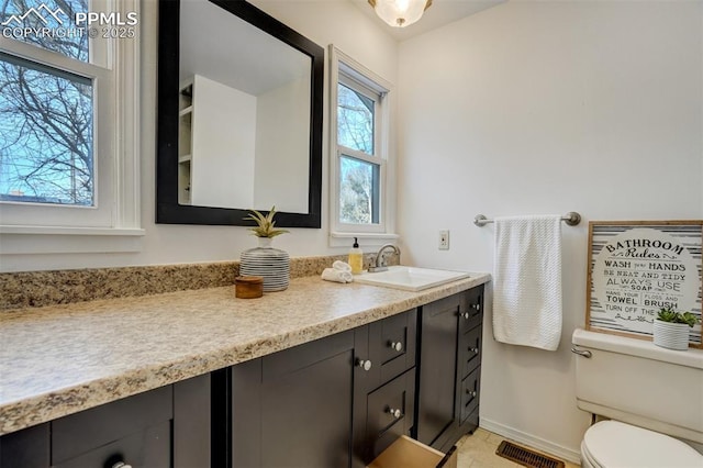 bathroom featuring vanity and toilet