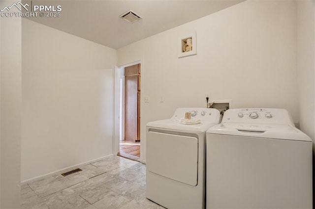 clothes washing area with independent washer and dryer