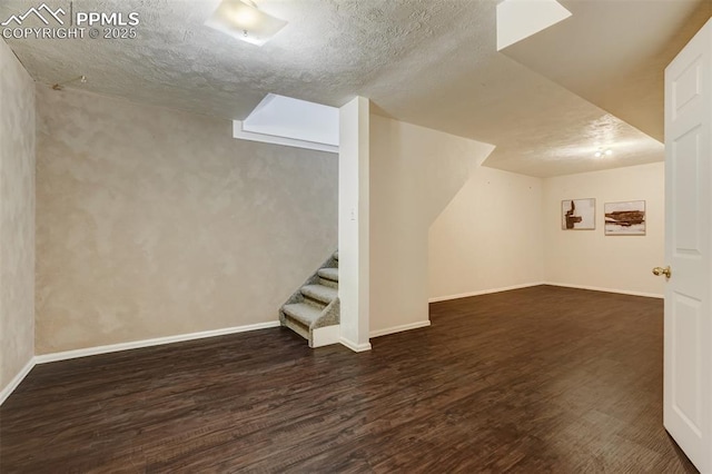 bonus room with dark hardwood / wood-style floors and a textured ceiling