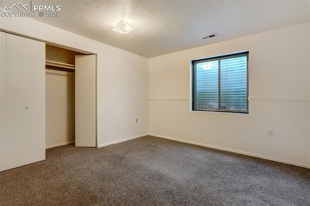 unfurnished bedroom with carpet floors and a closet