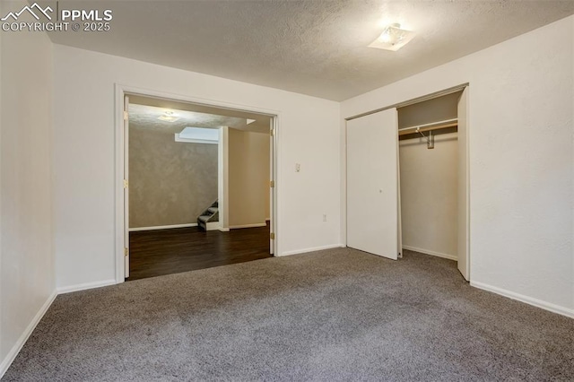 unfurnished bedroom featuring a closet and dark colored carpet