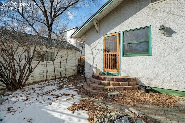 view of snow covered property entrance