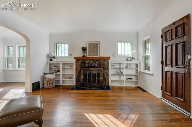 living room with hardwood / wood-style flooring, a fireplace, and a wealth of natural light