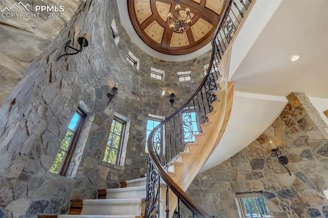 stairs with a high ceiling and an inviting chandelier