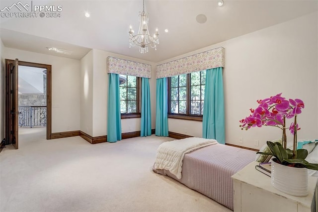 carpeted bedroom with a chandelier