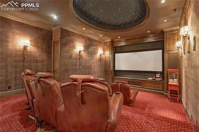 home theater room with carpet floors, a raised ceiling, and ornamental molding