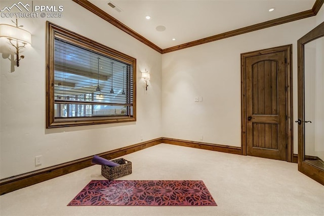 carpeted spare room with crown molding