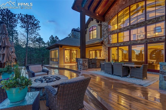 deck at dusk with a fire pit