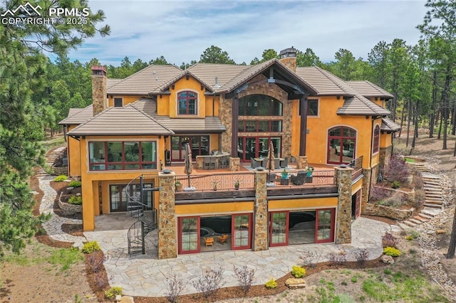 rear view of house featuring a wooden deck