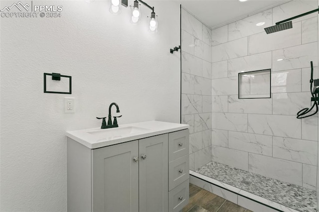 bathroom featuring vanity and tiled shower