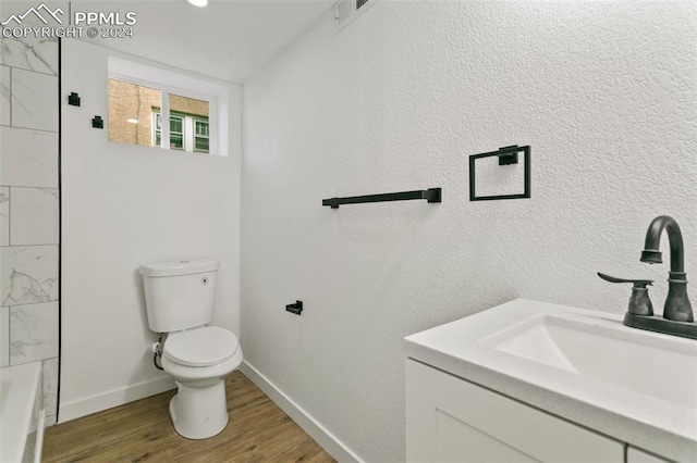 full bathroom featuring hardwood / wood-style floors, vanity, shower with separate bathtub, and toilet