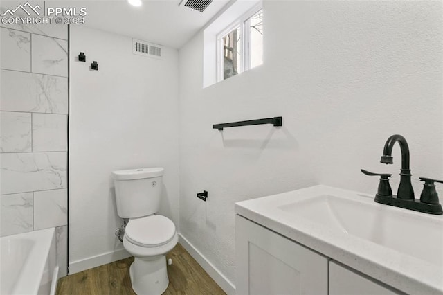 bathroom featuring hardwood / wood-style floors, vanity, and toilet