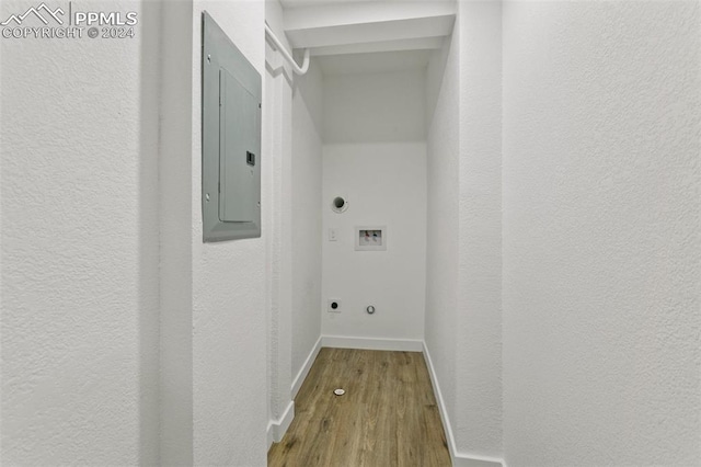 clothes washing area with electric dryer hookup, electric panel, gas dryer hookup, hookup for a washing machine, and wood-type flooring