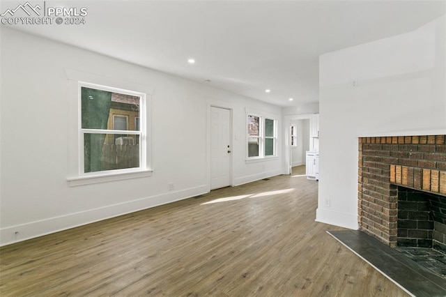 unfurnished living room featuring a fireplace and hardwood / wood-style floors