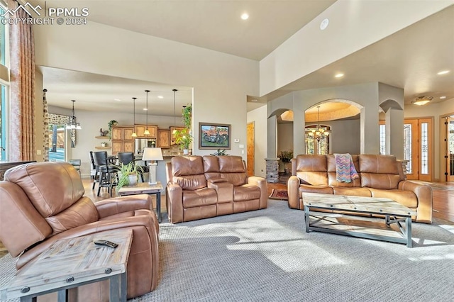 carpeted living room with a chandelier