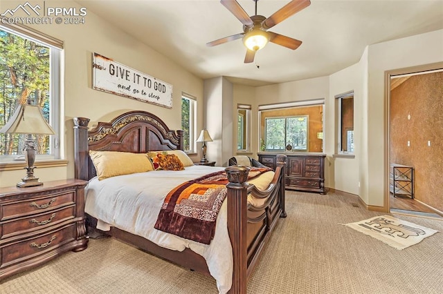 bedroom featuring ceiling fan and light carpet