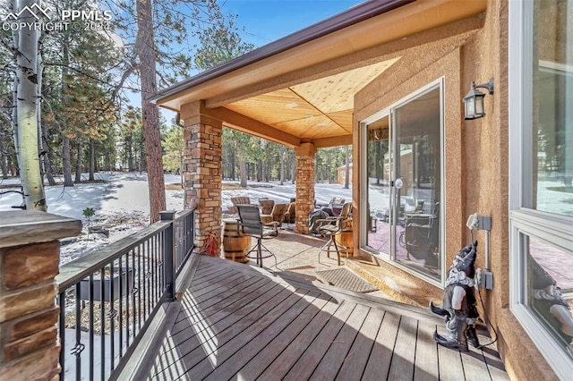 snow covered deck with covered porch