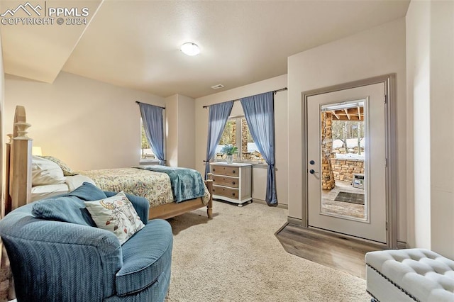 bedroom featuring light colored carpet