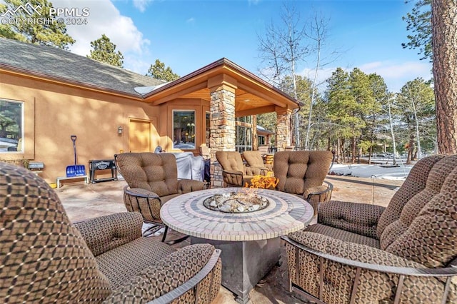 view of patio / terrace with an outdoor living space with a fire pit