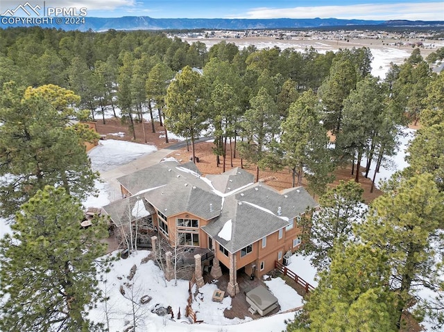 snowy aerial view featuring a mountain view