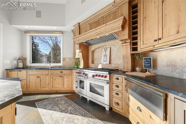 kitchen featuring decorative backsplash, light brown cabinetry, range with two ovens, and dark tile patterned floors