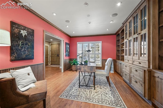 office area with light hardwood / wood-style floors, built in features, and ornamental molding