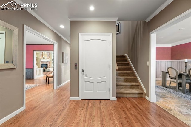 entryway featuring light hardwood / wood-style floors and ornamental molding