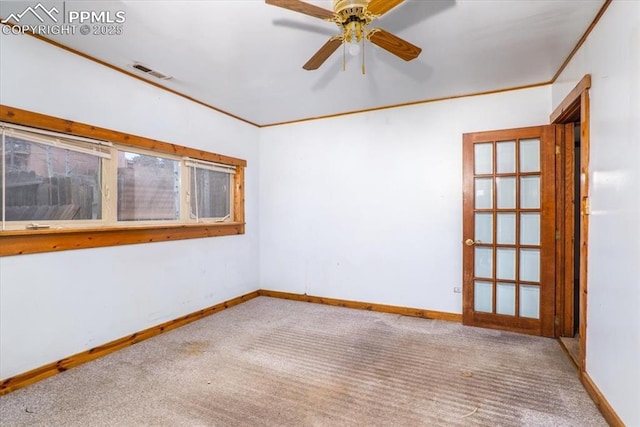 empty room with carpet flooring, ceiling fan, and ornamental molding