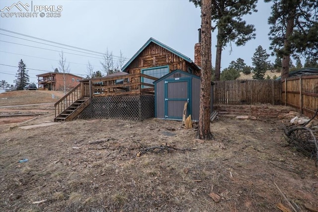 view of yard with a shed and a wooden deck