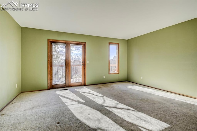 spare room featuring light colored carpet