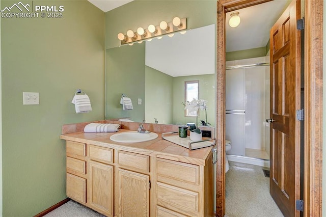 bathroom featuring a shower with door, vanity, and toilet