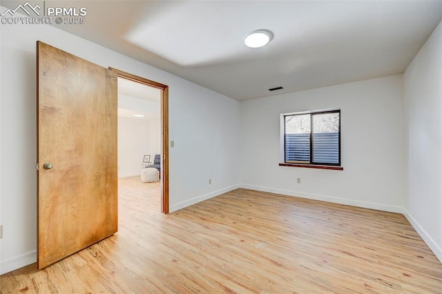 spare room with light hardwood / wood-style floors