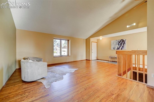 interior space with hardwood / wood-style floors and vaulted ceiling