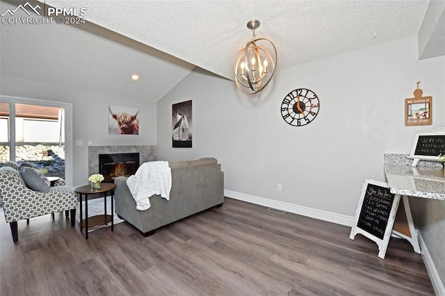 living room with a high end fireplace, a textured ceiling, lofted ceiling, a chandelier, and dark hardwood / wood-style flooring