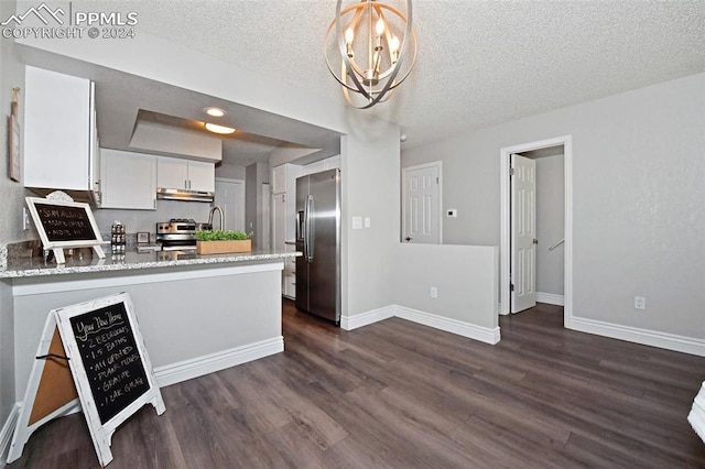 kitchen featuring appliances with stainless steel finishes, white cabinets, pendant lighting, dark hardwood / wood-style floors, and kitchen peninsula