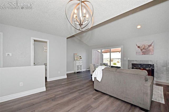 living room with a high end fireplace, a notable chandelier, a textured ceiling, lofted ceiling, and dark hardwood / wood-style flooring