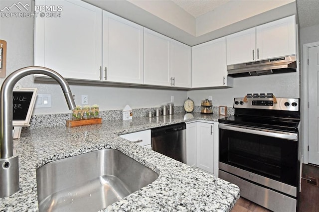 kitchen featuring appliances with stainless steel finishes, sink, white cabinetry, and light stone countertops