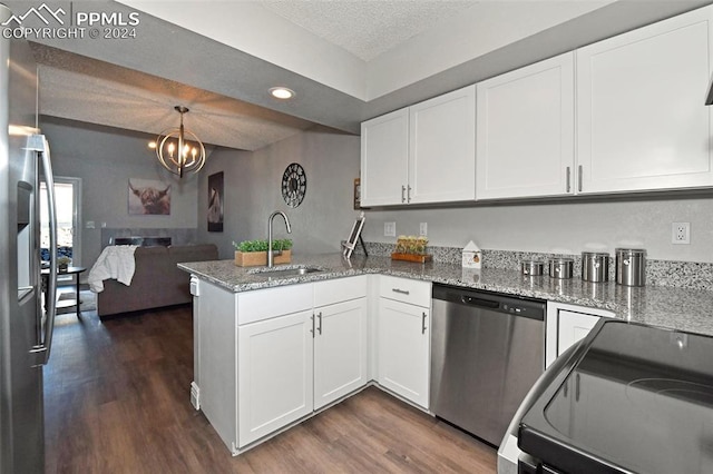 kitchen featuring white cabinetry, kitchen peninsula, stainless steel appliances, sink, and pendant lighting