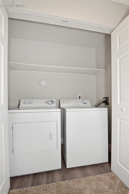 laundry area with washer and clothes dryer and dark hardwood / wood-style floors