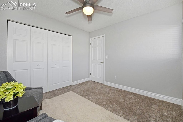 bedroom with ceiling fan, carpet flooring, and a closet