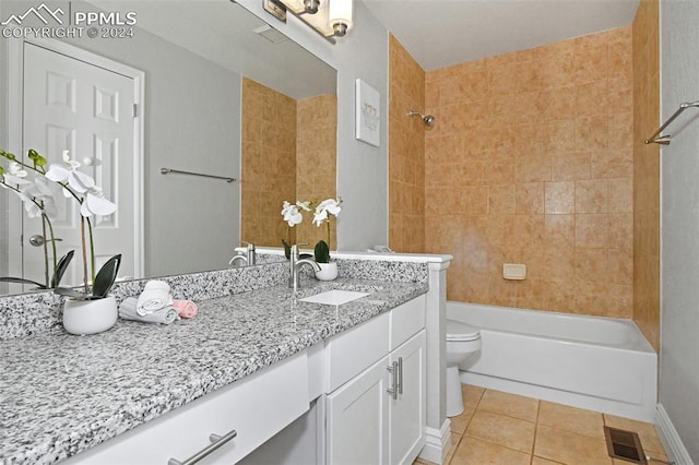 full bathroom featuring tiled shower / bath combo, tile patterned flooring, vanity, and toilet