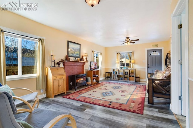 living room featuring ceiling fan, dark wood-type flooring, and a wealth of natural light