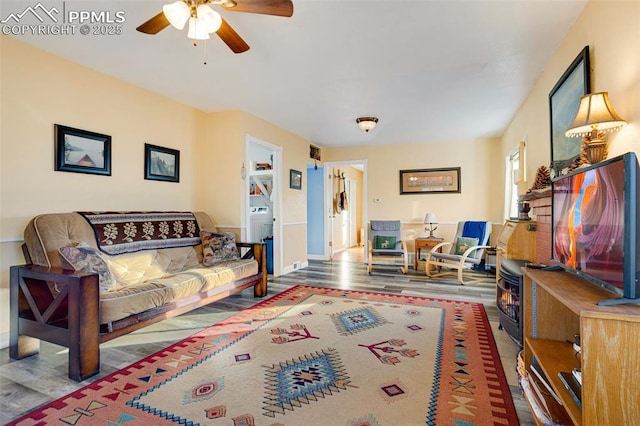 living room with hardwood / wood-style flooring and ceiling fan