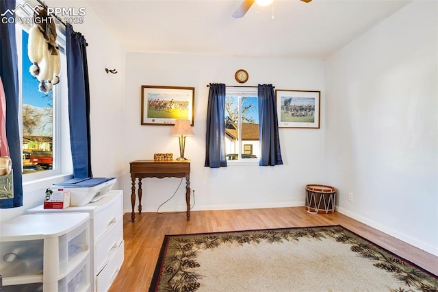 sitting room with ceiling fan and hardwood / wood-style flooring