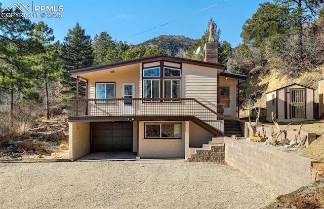 view of front of house featuring a mountain view and a garage