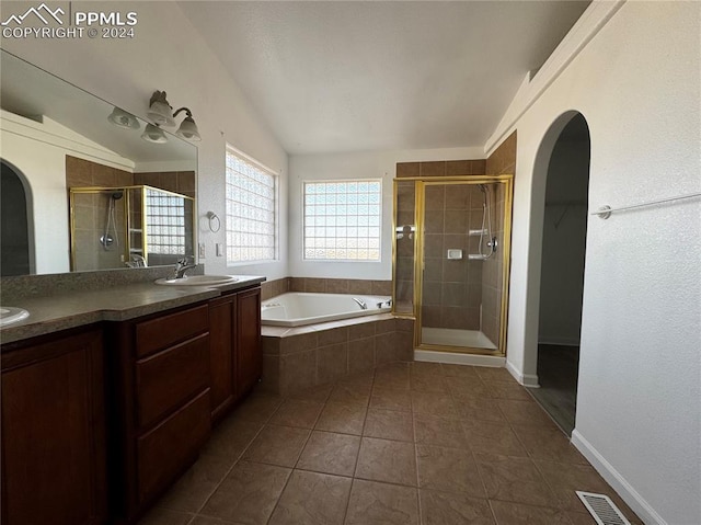 bathroom featuring tile patterned floors, vanity, independent shower and bath, and lofted ceiling