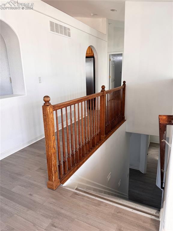 stairway with hardwood / wood-style floors