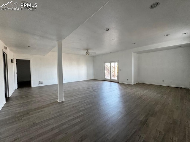 empty room with ceiling fan and dark hardwood / wood-style floors