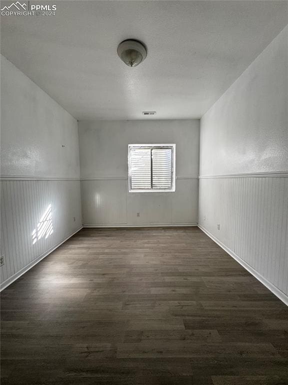 empty room featuring dark wood-type flooring